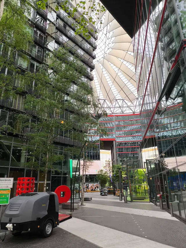 photo of a mall? with windows at the top and tall plants